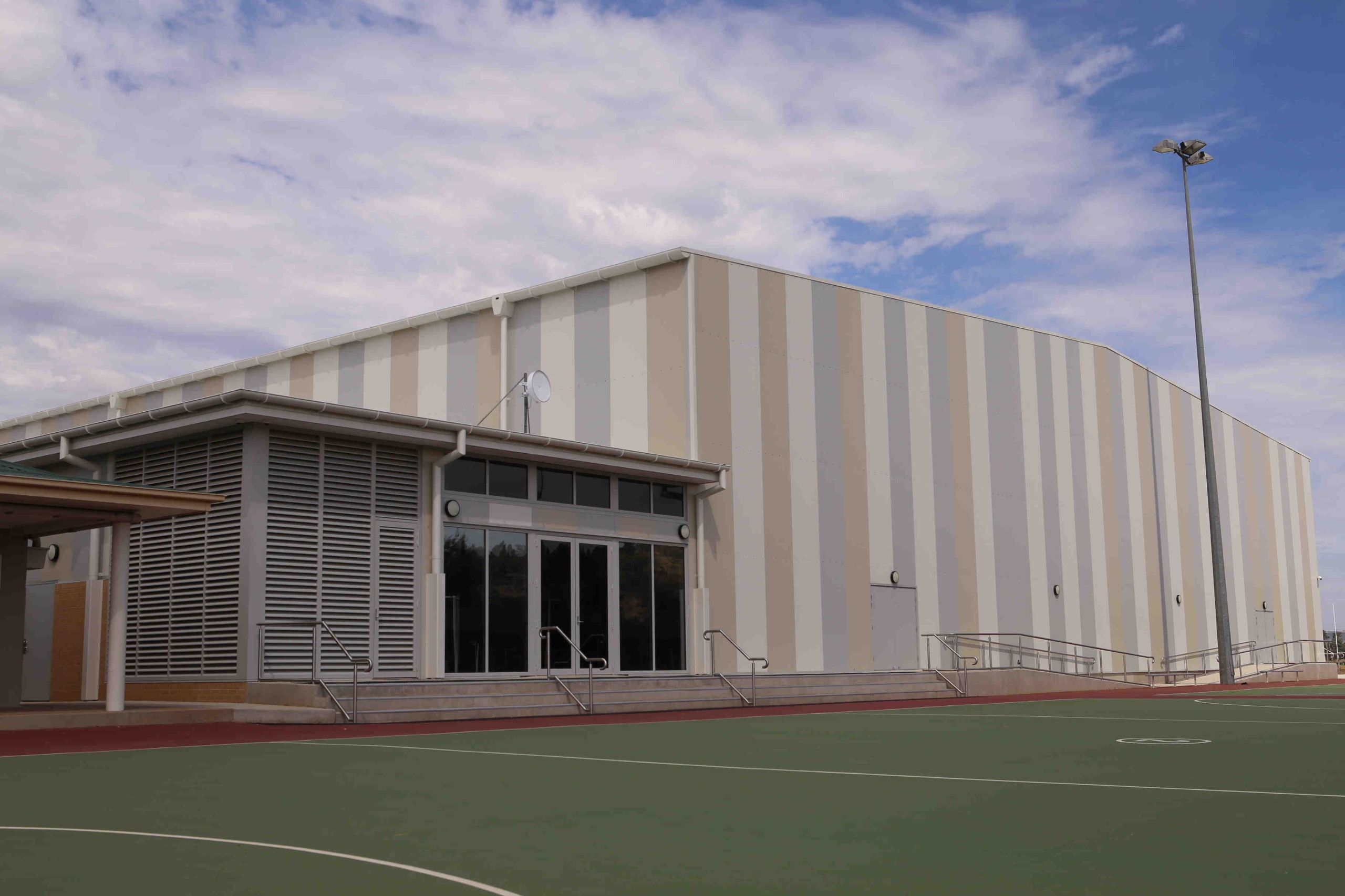 Exterior view of large indoor sports stadium.