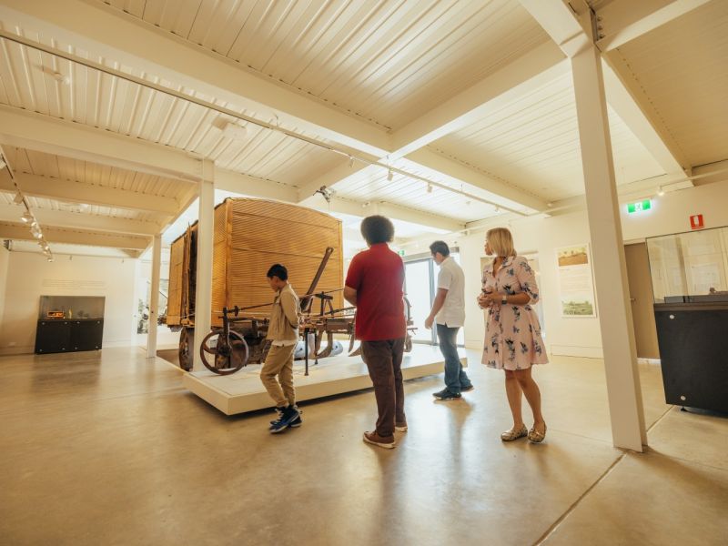 Family looking at exhibition of artefacts in Museum of the Riverina.