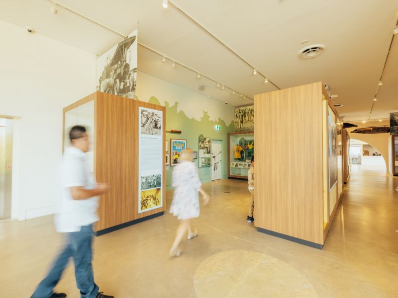 Adult male and child looking at exhibition in Museum of Riverina.